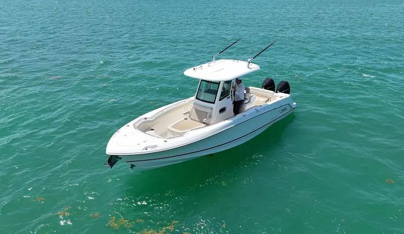  Yacht Photos Pics 2022 Boston Whaler 280 Outrage boat on clear turquoise water.