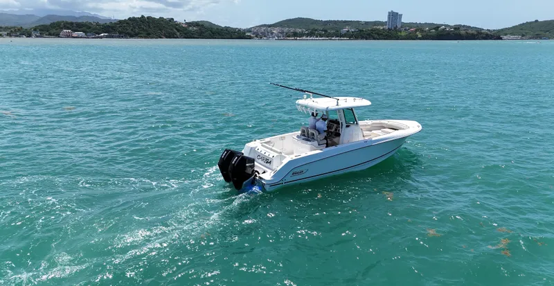  Yacht Photos Pics 2022 Boston Whaler 280 Outrage boat cruising on turquoise waters.