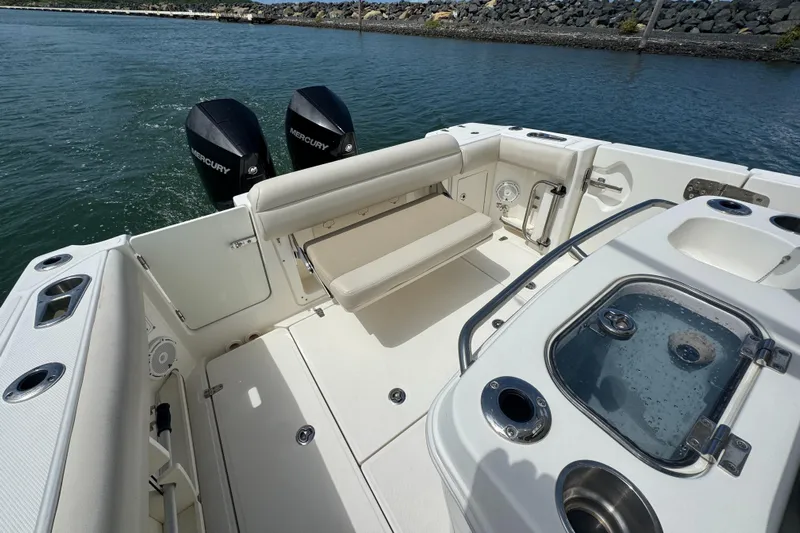  Yacht Photos Pics 2022 Boston Whaler 280 Outrage boat interior with seating and dual Mercury engines.