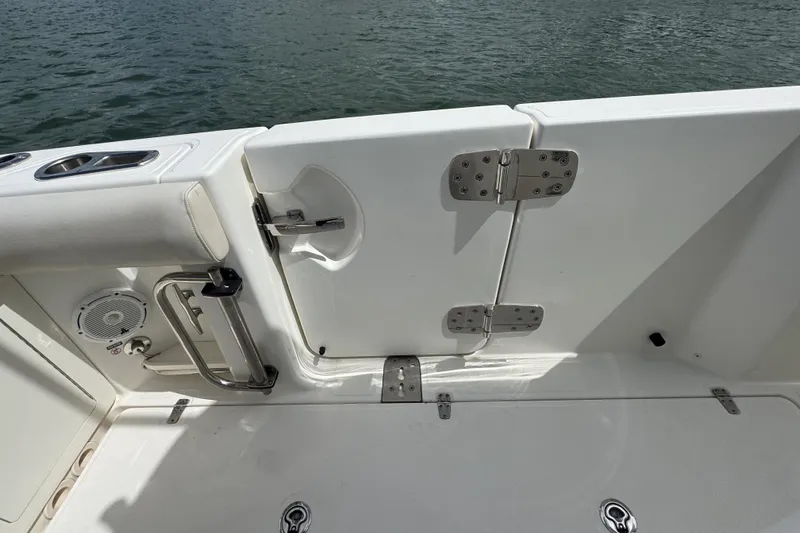  Yacht Photos Pics 2022 Boston Whaler 280 Outrage boat deck with open hatch and water view.
