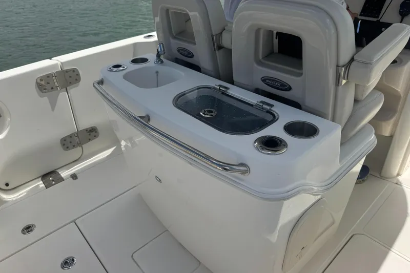  Yacht Photos Pics 2022 Boston Whaler 280 Outrage boat interior with seating and utility station.