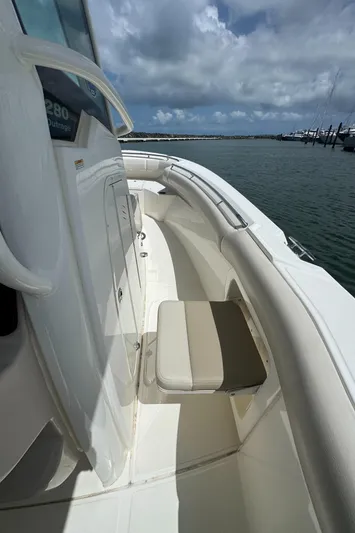  Yacht Photos Pics 2022 Boston Whaler 280 Outrage boat, featuring sleek seating and ocean backdrop.