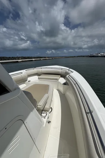  Yacht Photos Pics 2022 Boston Whaler 280 Outrage boat on water under cloudy sky.