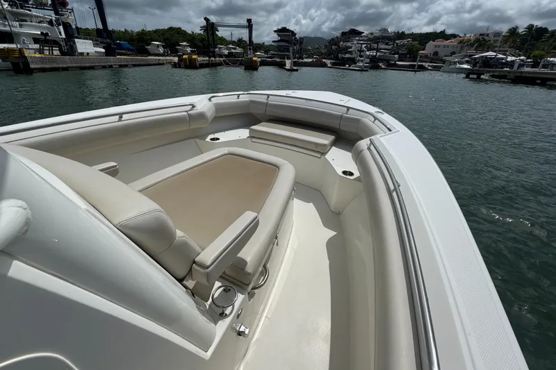 Yacht Photos Pics 2022 Boston Whaler 280 Outrage boat with spacious seating, docked at a marina.