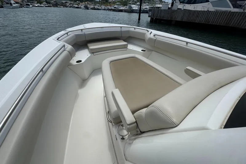  Yacht Photos Pics 2022 Boston Whaler 280 Outrage boat interior with beige seating and spacious layout.