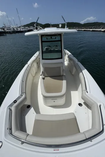  Yacht Photos Pics 2022 Boston Whaler 280 Outrage boat with spacious seating, docked in a marina.