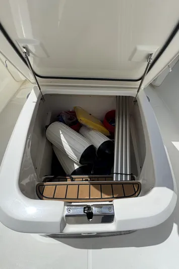  Yacht Photos Pics Storage compartment on a 2022 Boston Whaler 280 Outrage boat, containing marine equipment.
