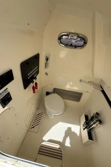  Yacht Photos Pics 2022 Boston Whaler 280 Outrage interior cabin with toilet and control panel.