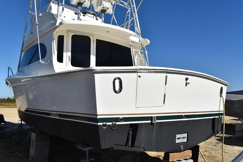  Yacht Photos Pics 2005 Egg Harbor 37 Sport Yacht on dry dock, white exterior, clear blue sky.