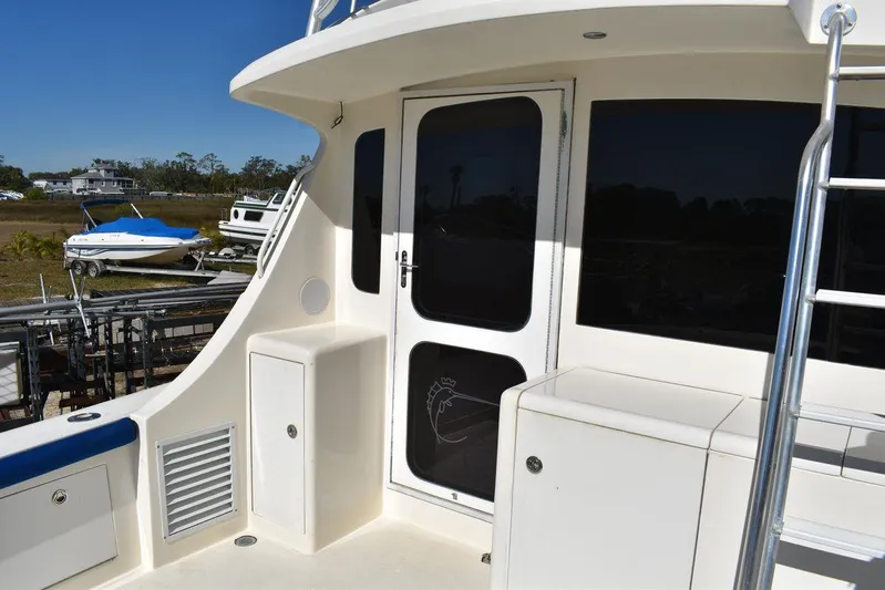  Yacht Photos Pics 2005 Egg Harbor 37 Sport Yacht deck with door and storage compartments.