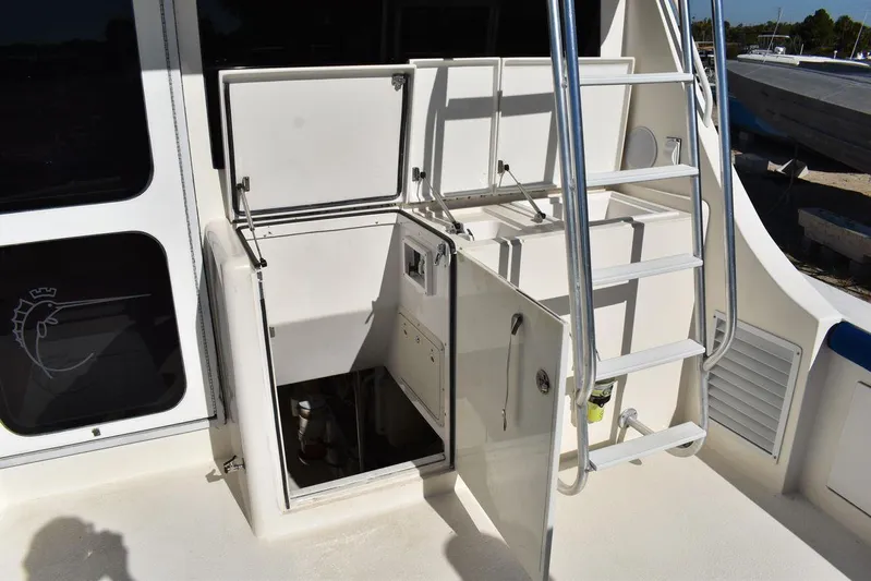  Yacht Photos Pics 2005 Egg Harbor 37 Sport Yacht deck with open storage compartments and ladder.