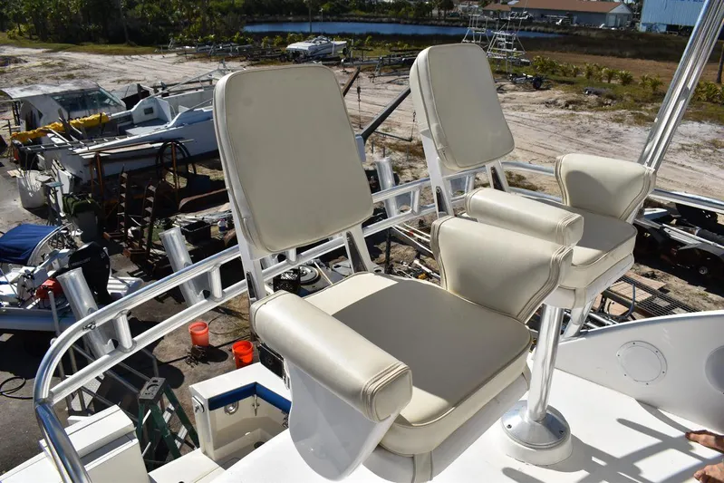  Yacht Photos Pics Egg Harbor 37 Sport Yacht 2005 helm chairs, outdoor setting, marina background.