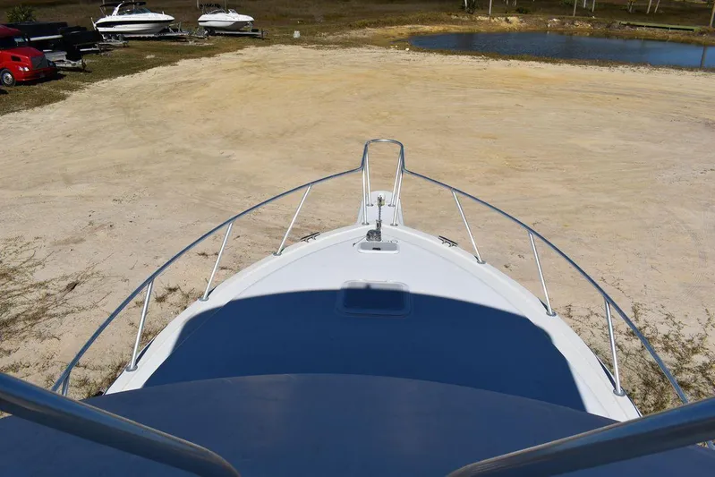  Yacht Photos Pics Egg Harbor 37 Sport Yacht 2005, bow view on dry land with parked boats nearby.