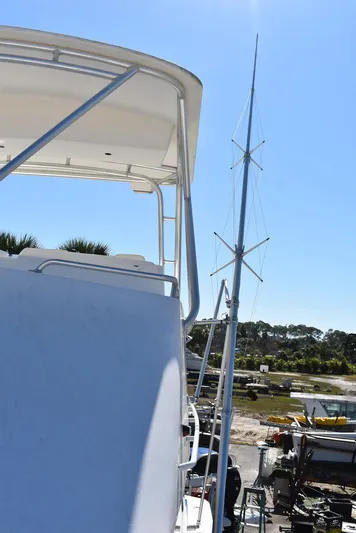  Yacht Photos Pics 2005 Egg Harbor 37 Sport Yacht with tall antenna, docked under clear blue sky.