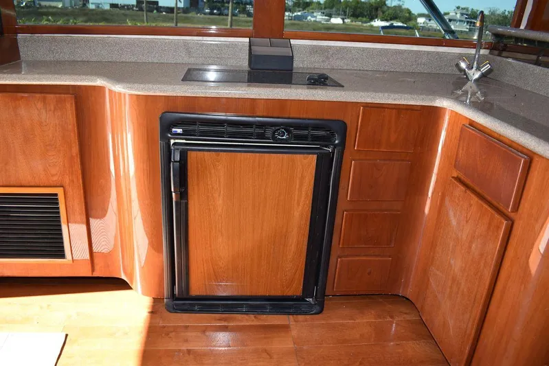  Yacht Photos Pics 2005 Egg Harbor 37 Sport Yacht kitchen with wood cabinetry and compact appliances.