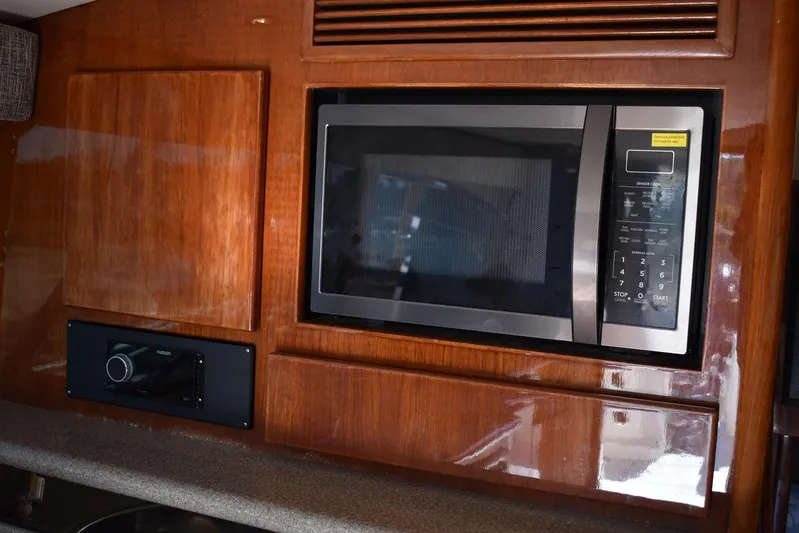  Yacht Photos Pics Microwave in 2005 Egg Harbor 37 Sport Yacht kitchen with wooden cabinetry.