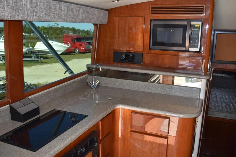  Yacht Photos Pics Interior of 2005 Egg Harbor 37 Sport Yacht kitchen with modern appliances and wood cabinetry.