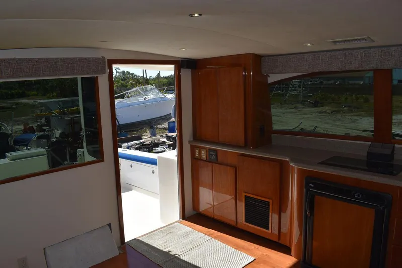  Yacht Photos Pics Interior of 2005 Egg Harbor 37 Sport Yacht with wooden cabinetry and outdoor view.