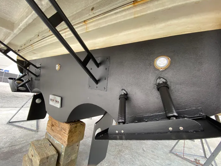 Off Line Yacht Photos Pics 2006 Cruisers Yachts 52 Express hull detail with trim tabs and supports.