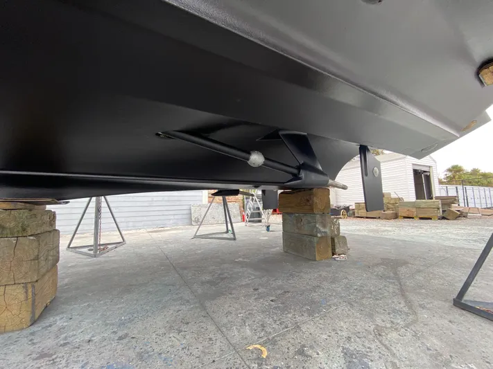 Off Line Yacht Photos Pics 2006 Cruisers Yachts 52 Express underbody on blocks, showcasing hull and support structure.