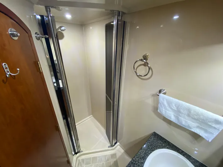 Off Line Yacht Photos Pics Luxurious bathroom in 2006 Cruisers Yachts 52 Express with shower and modern fixtures.