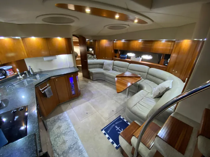 Off Line Yacht Photos Pics Luxurious interior of 2006 Cruisers Yachts 52 Express with modern kitchen and cozy seating area.