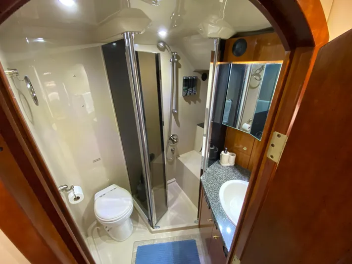 Off Line Yacht Photos Pics Luxurious bathroom in 2006 Cruisers Yachts 52 Express with shower and vanity.