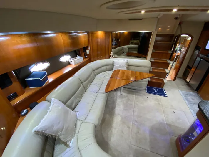 Off Line Yacht Photos Pics Luxurious interior of 2006 Cruisers Yachts 52 Express with plush seating and elegant wood finishes.