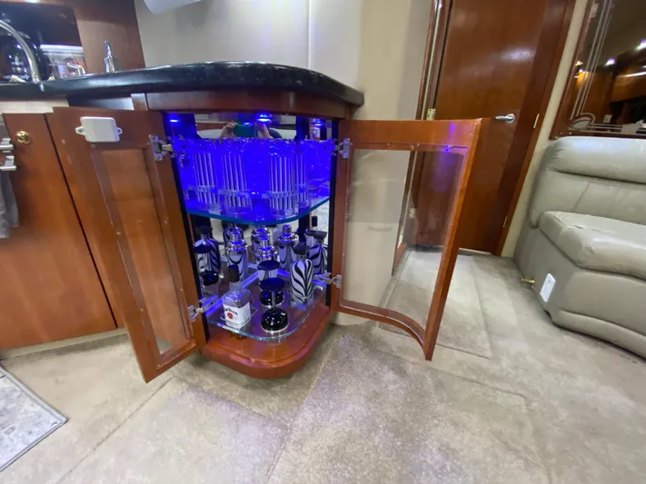 Off Line Yacht Photos Pics Luxury yacht interior with illuminated liquor cabinet, Cruisers Yachts 52 Express, 2006 model.