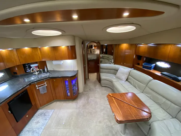 Off Line Yacht Photos Pics Luxurious 2006 Cruisers Yachts 52 Express interior with modern kitchen and cozy seating area.