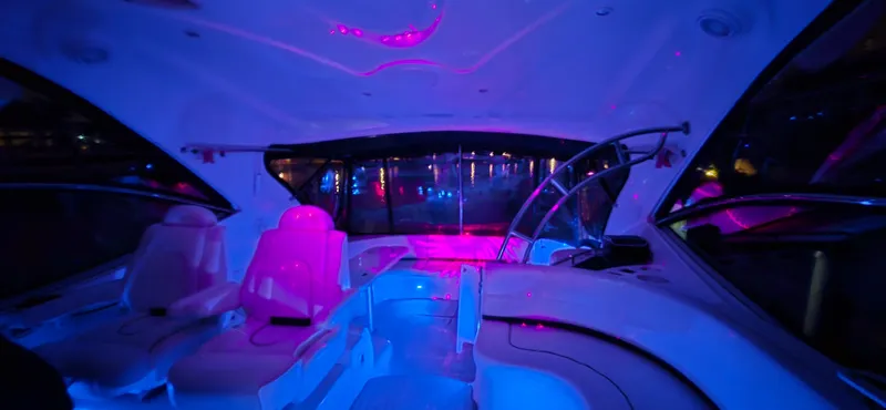 Off Line Yacht Photos Pics Interior of 2006 Cruisers Yachts 52 Express with vibrant blue and pink lighting.
