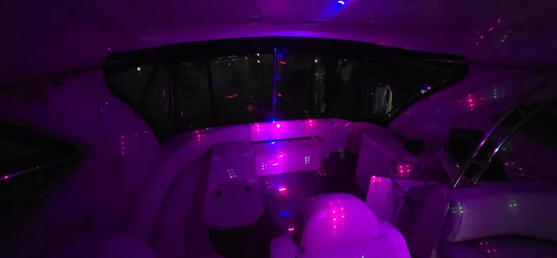 Off Line Yacht Photos Pics Interior of 2006 Cruisers Yachts 52 Express with ambient purple lighting.