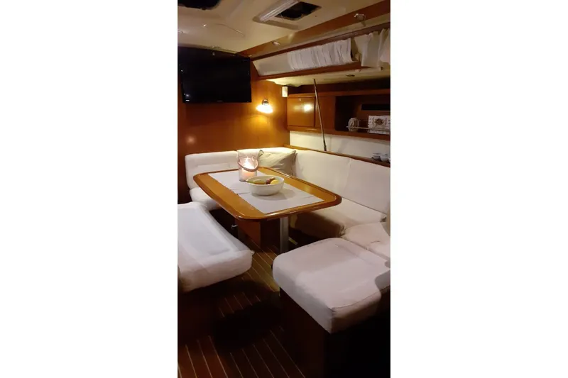  Yacht Photos Pics Interior of 2007 Dufour Yachts 425 Grand Large, featuring cozy dining area with soft lighting.