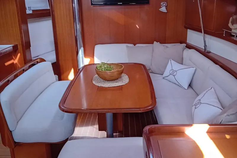  Yacht Photos Pics Luxurious interior of 2007 Dufour Yachts 425 Grand Large with cozy seating and wooden table.
