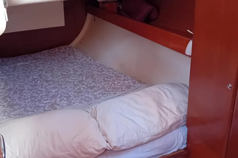  Yacht Photos Pics Cozy cabin interior of 2007 Dufour Yachts 425 Grand Large with patterned bedding.