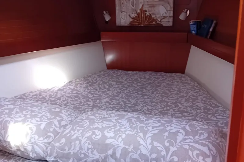  Yacht Photos Pics Cozy cabin interior of 2007 Dufour Yachts 425 Grand Large with patterned bedding.