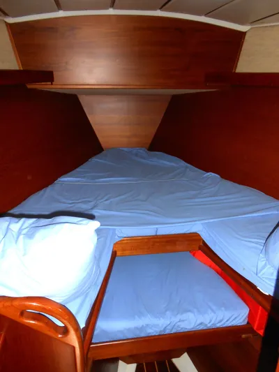 Dutchess Yacht Photos Pics Cozy cabin interior of 1985 Contest 41 Ketch sailboat with blue bedding.
