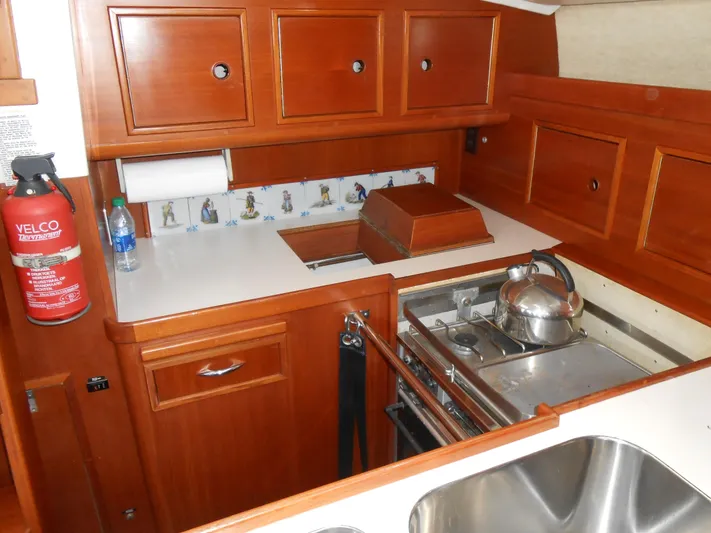 Dutchess Yacht Photos Pics 1985 Contest 41 Ketch kitchen with wooden cabinets, stove, and sink.
