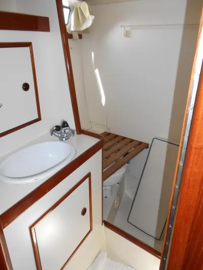 Dutchess Yacht Photos Pics 1985 Contest 41 Ketch bathroom with sink, wooden accents, and storage cabinets.