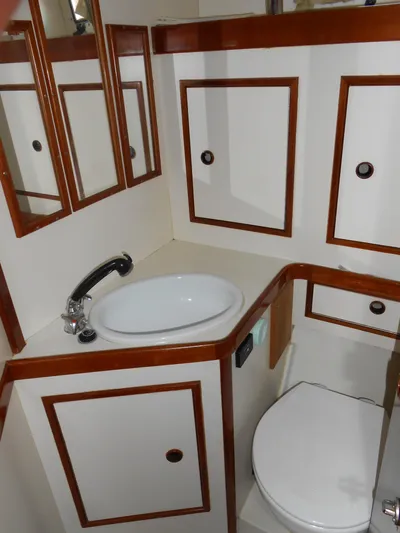 Dutchess Yacht Photos Pics 1985 Contest 41 Ketch bathroom with sink, mirror, and storage cabinets.