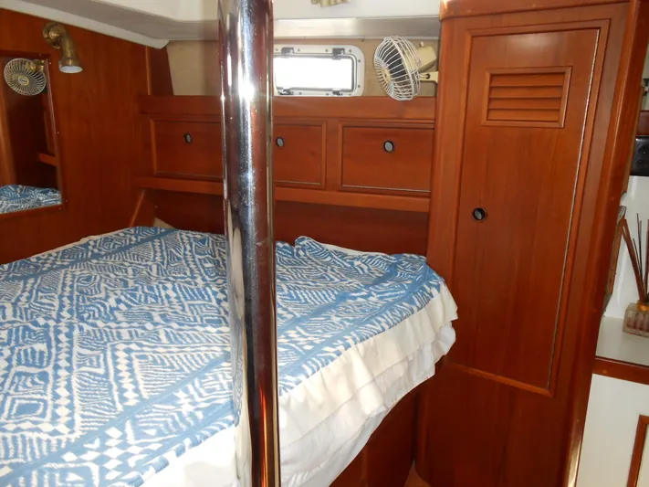 Dutchess Yacht Photos Pics 1985 Contest 41 Ketch cabin with wooden interior and blue patterned bedding.