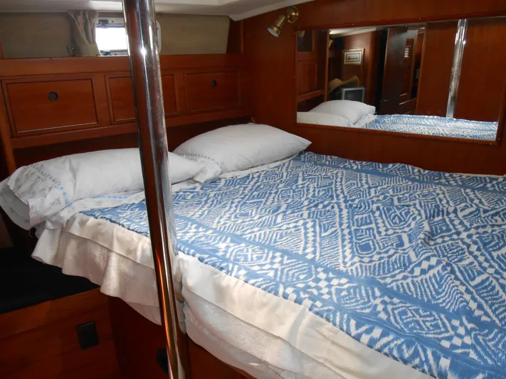 Dutchess Yacht Photos Pics Cozy cabin interior of 1985 Contest 41 Ketch with blue patterned bedding.