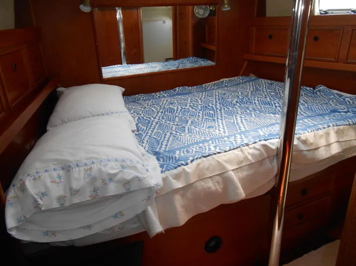 Dutchess Yacht Photos Pics Cozy cabin interior of 1985 Contest 41 Ketch with blue patterned bedding.