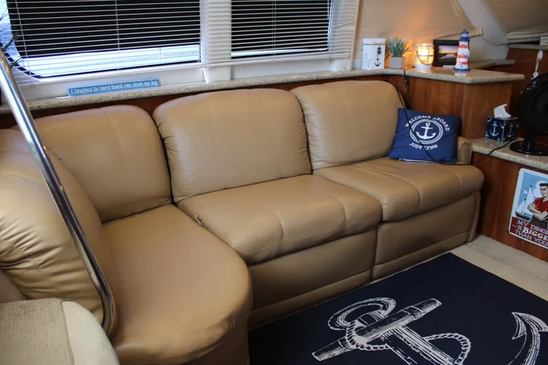  Yacht Photos Pics Luxurious interior of 2002 Carver 356 Motor Yacht with beige leather sofa and nautical decor.