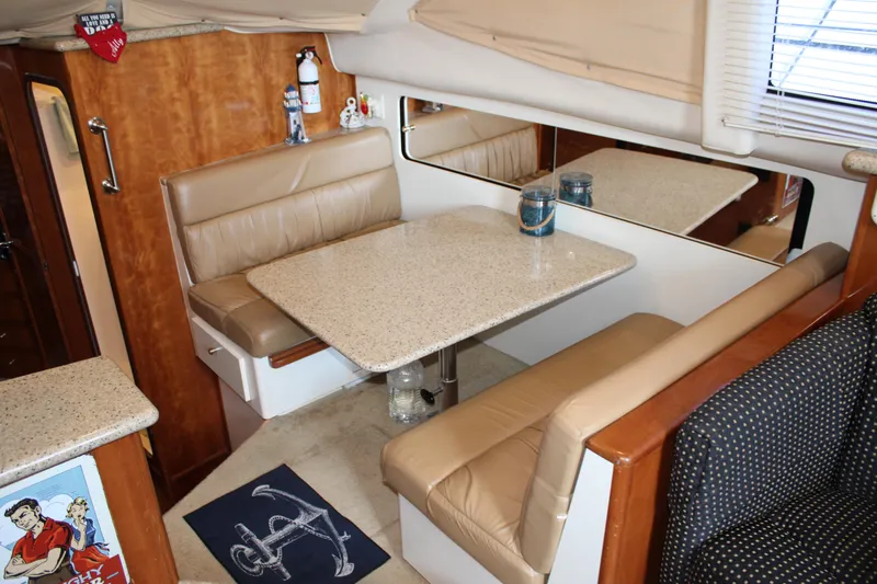  Yacht Photos Pics Interior of 2002 Carver 356 Motor Yacht with beige seating and dining table.