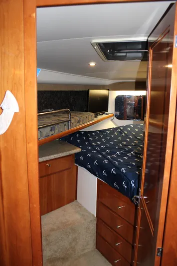  Yacht Photos Pics 2002 Carver 356 Motor Yacht cabin with wooden cabinetry and cozy bedding.