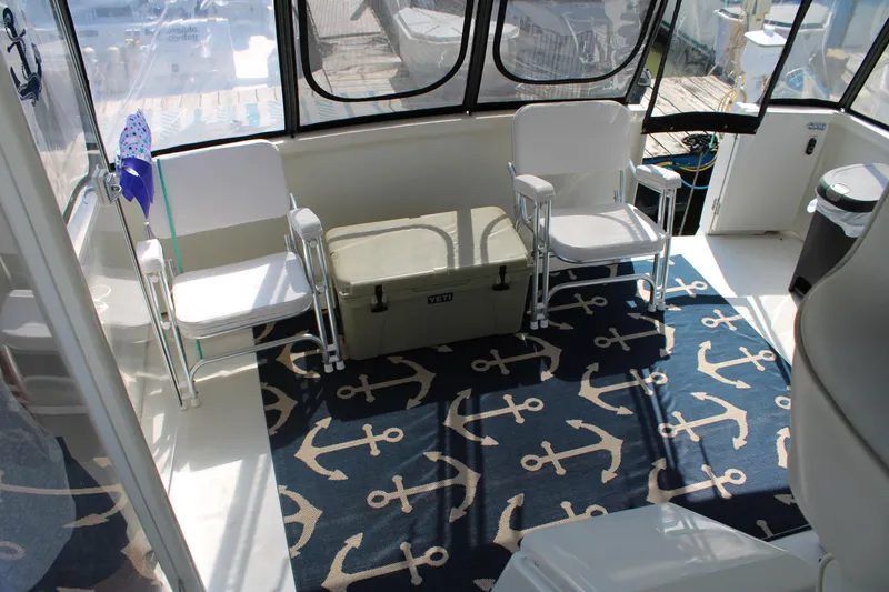  Yacht Photos Pics 2002 Carver 356 Motor Yacht interior with anchor-themed rug and seating area.