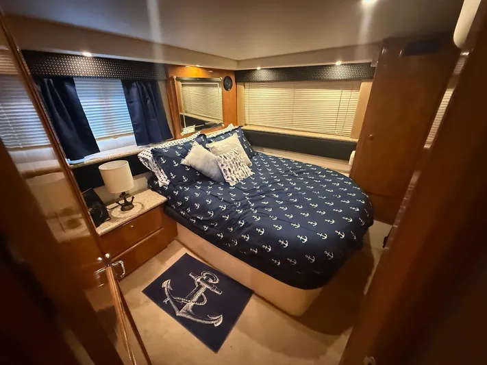  Yacht Photos Pics Luxurious bedroom in 2002 Carver 356 Motor Yacht with nautical-themed decor.