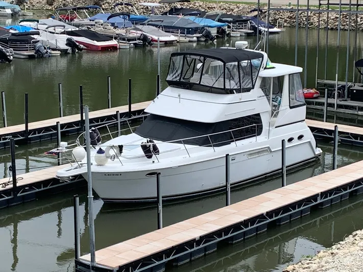  Yacht Photos Pics 2002 Carver 356 Motor Yacht docked in a marina with other boats.