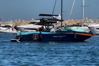 2020 MasterCraft X26 boat in a marina, surrounded by other yachts.